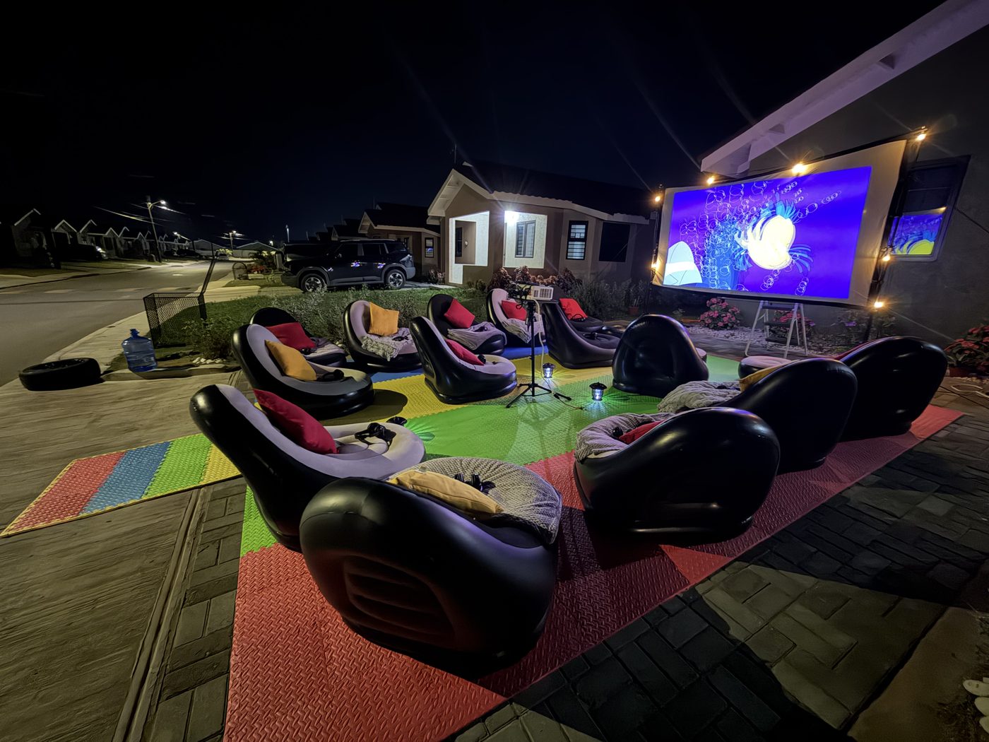 Di Nex outdoor cinema screen lit at night