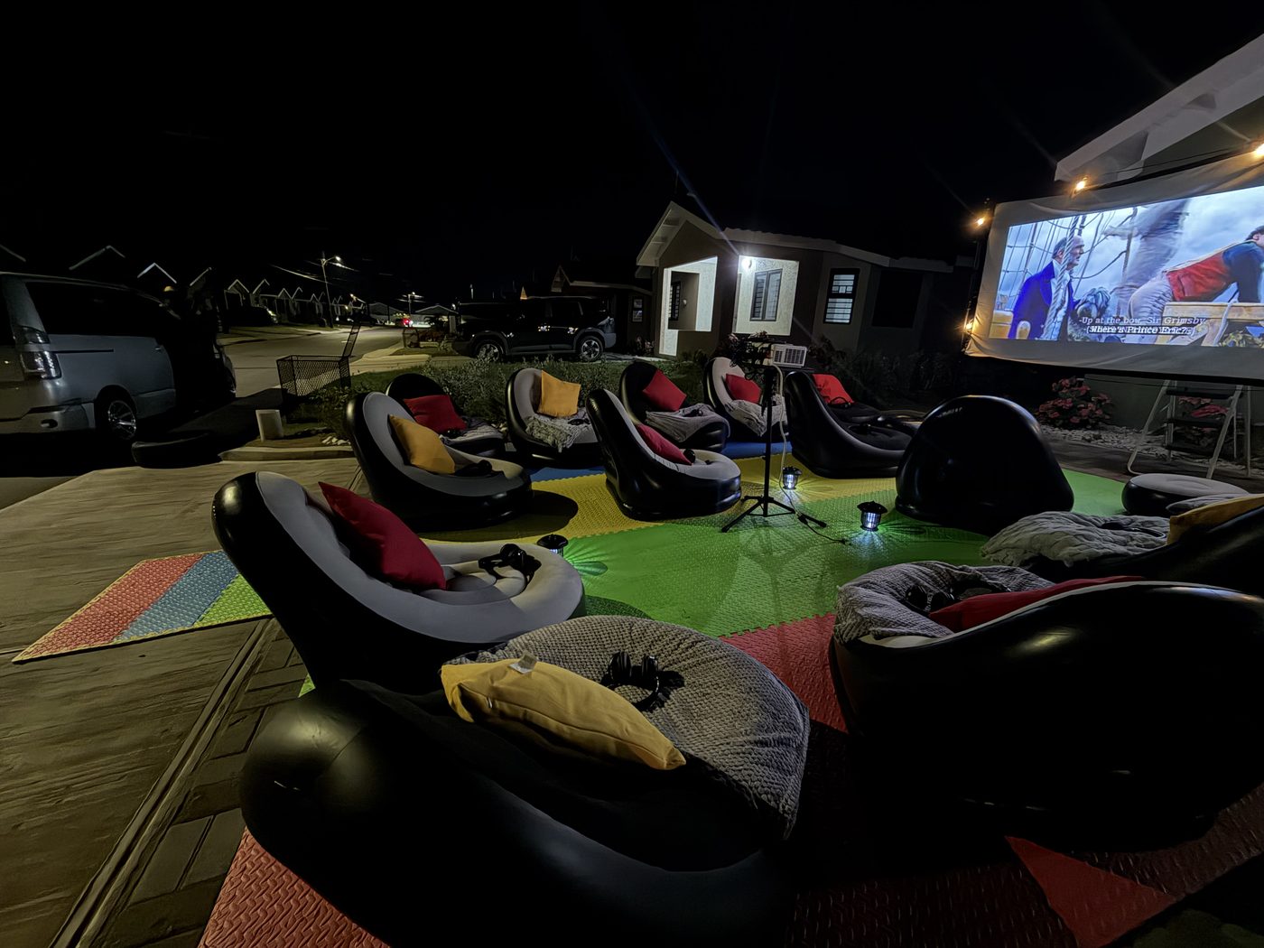 Close angle of inflatable chairs at Oak Estate — screen glowing in background