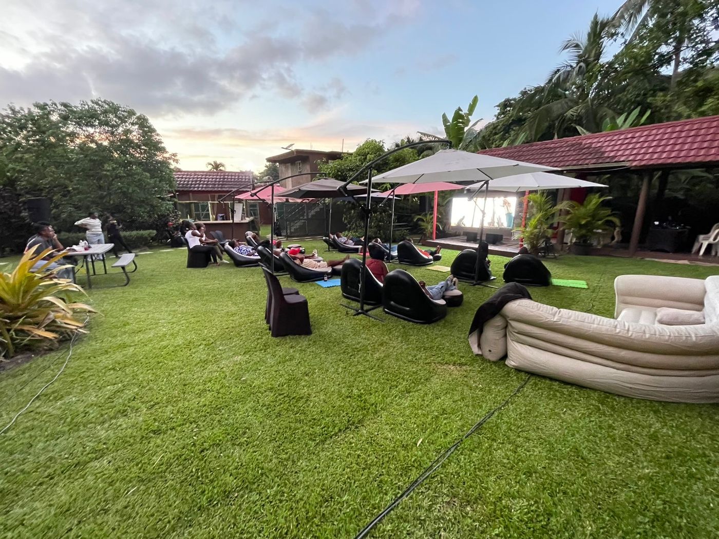 Di Nex Adventure private outdoor cinema set up on a lawn in Jamaica with guests seated for an evening screening