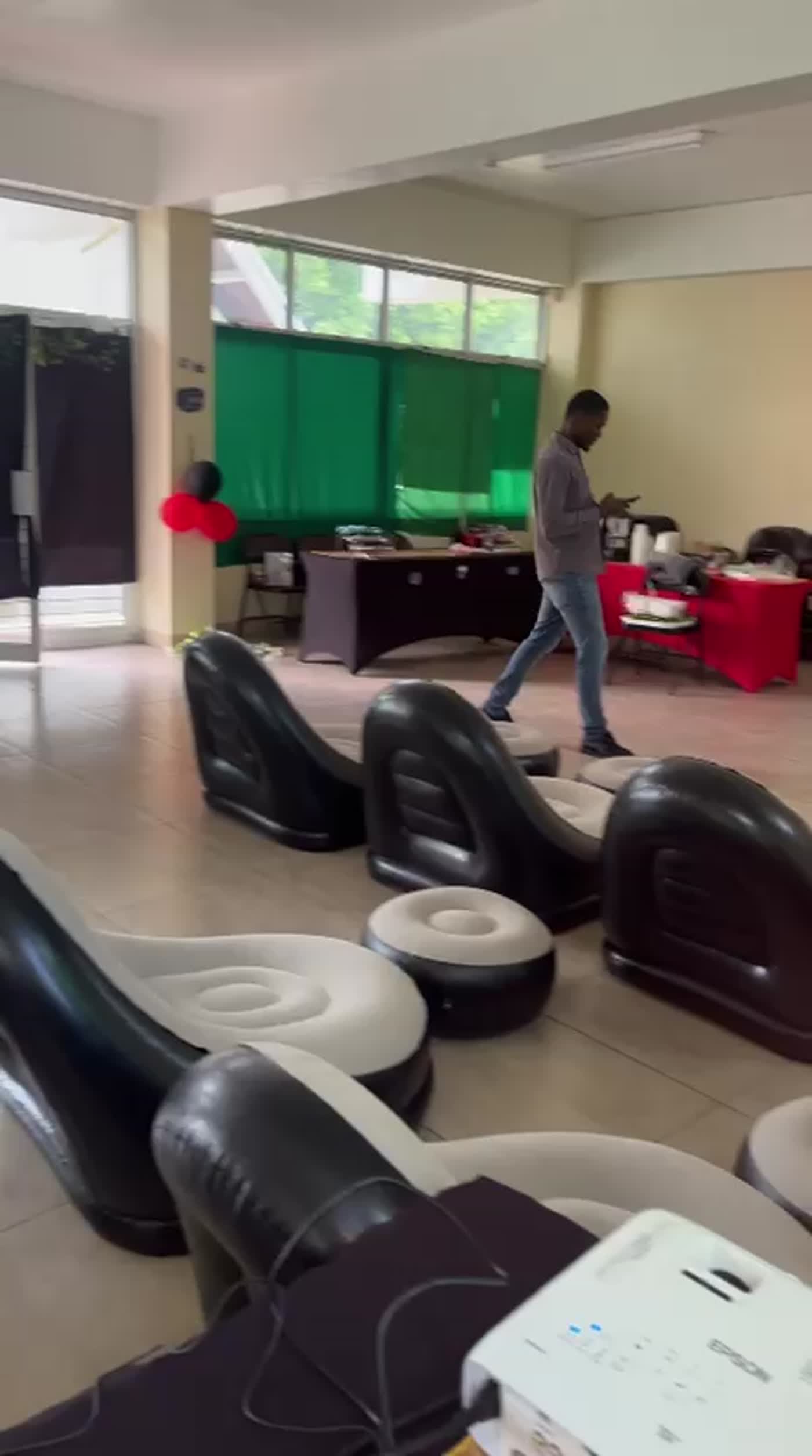 Setup in progress at Providence Methodist ELI — inflatable loungers on school hall floor