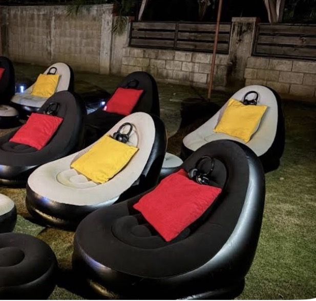 Silent cinema headphones resting on inflatable outdoor seating at a Di Nex Adventure event in Jamaica
